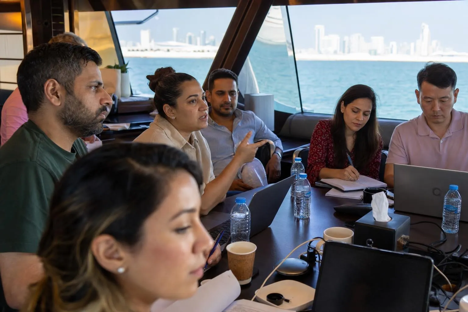 A team mid-programme on Boardroom Afloat — Dubai, Dubai Harbour or Dubai Marina, offshore along the coastline.