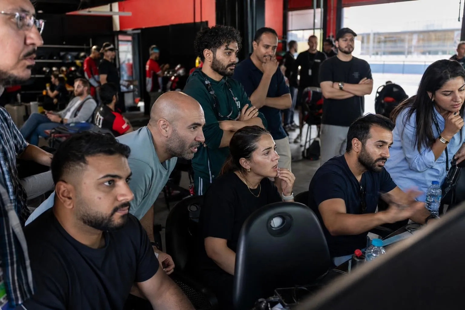 A team mid-programme on Grand Prix — Dubai, Dubai Autodrome or an indoor karting circuit.
