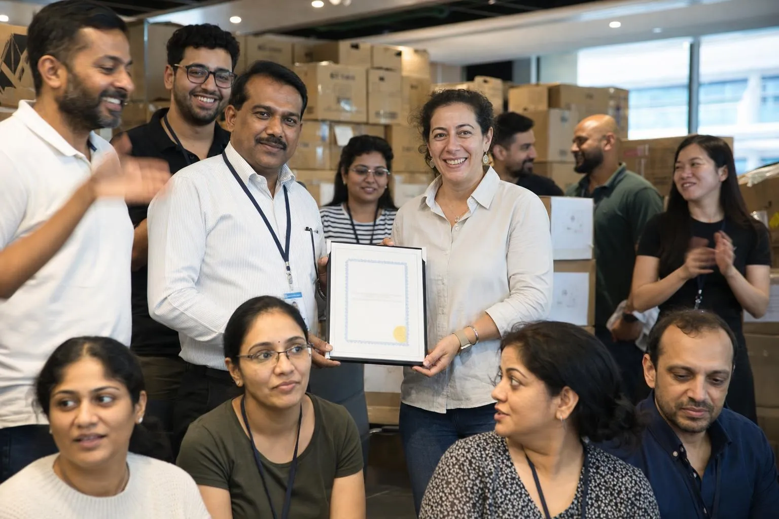 A team mid-programme on Pack for Good — Dubai, hotel function room, warehouse space or the client's own office atrium.