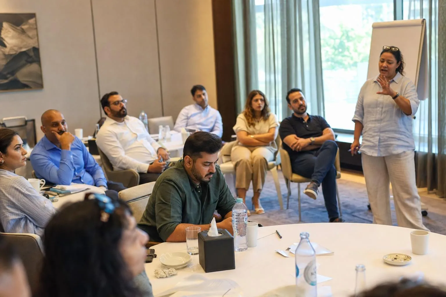 A team mid-programme on The Leadership Track — Dubai or Abu Dhabi, hotel meeting suites; the farm option applies to the Alignment Day.