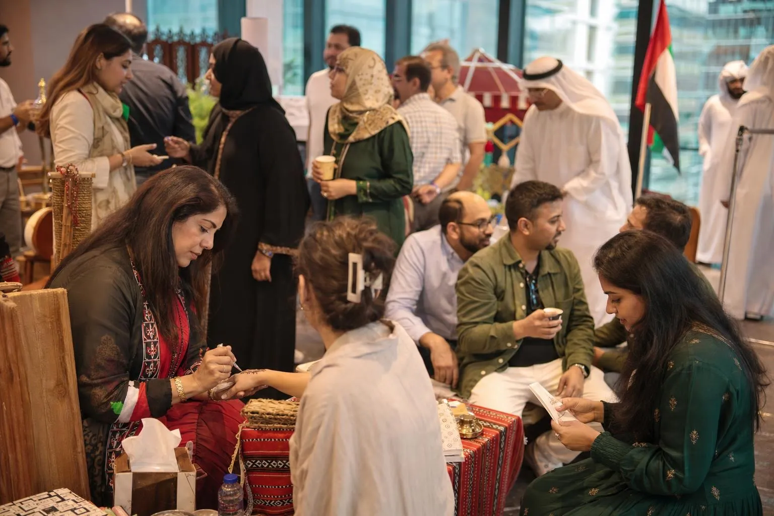 A team mid-programme on Union Day — Anywhere in the UAE, the client's own office atrium, or a hotel function room.