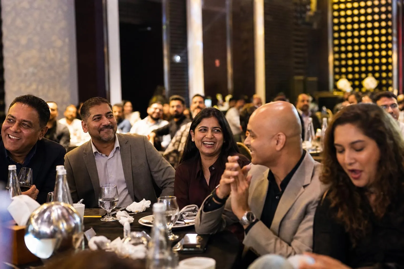 A team mid-programme on Year in Review — Dubai, Abu Dhabi or Sharjah, hotel ballroom.